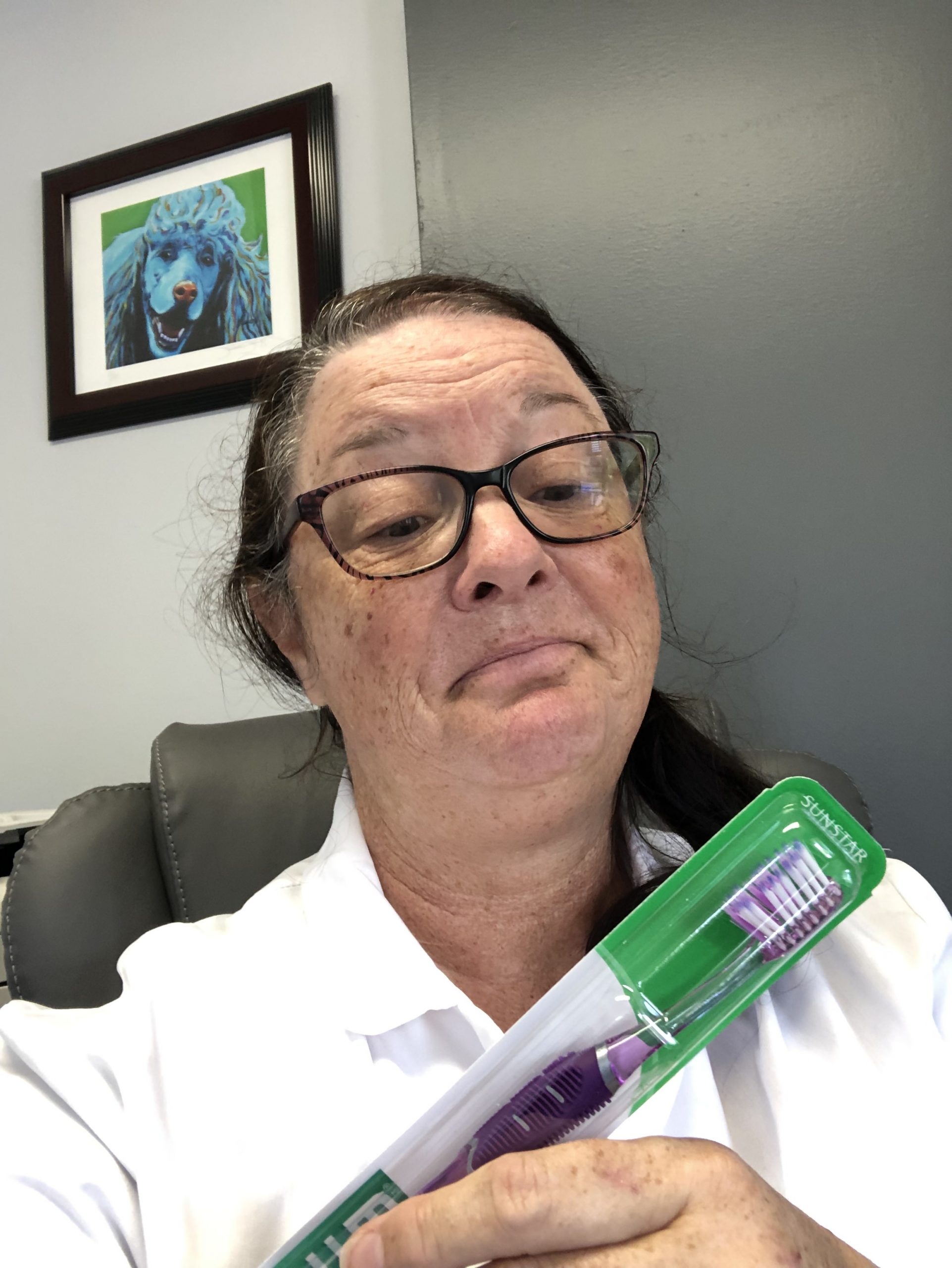 woman looking at new toothbrush